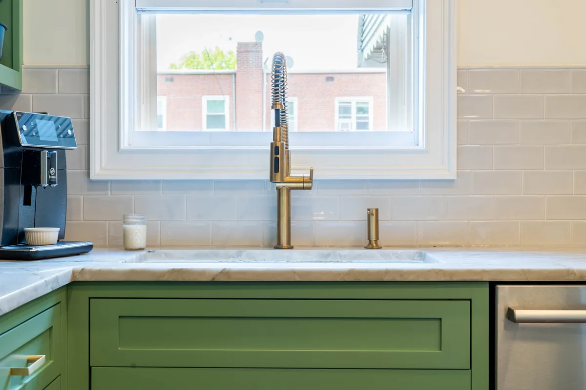 Master plumber installing kitchen plumbing equipment in a Florida home