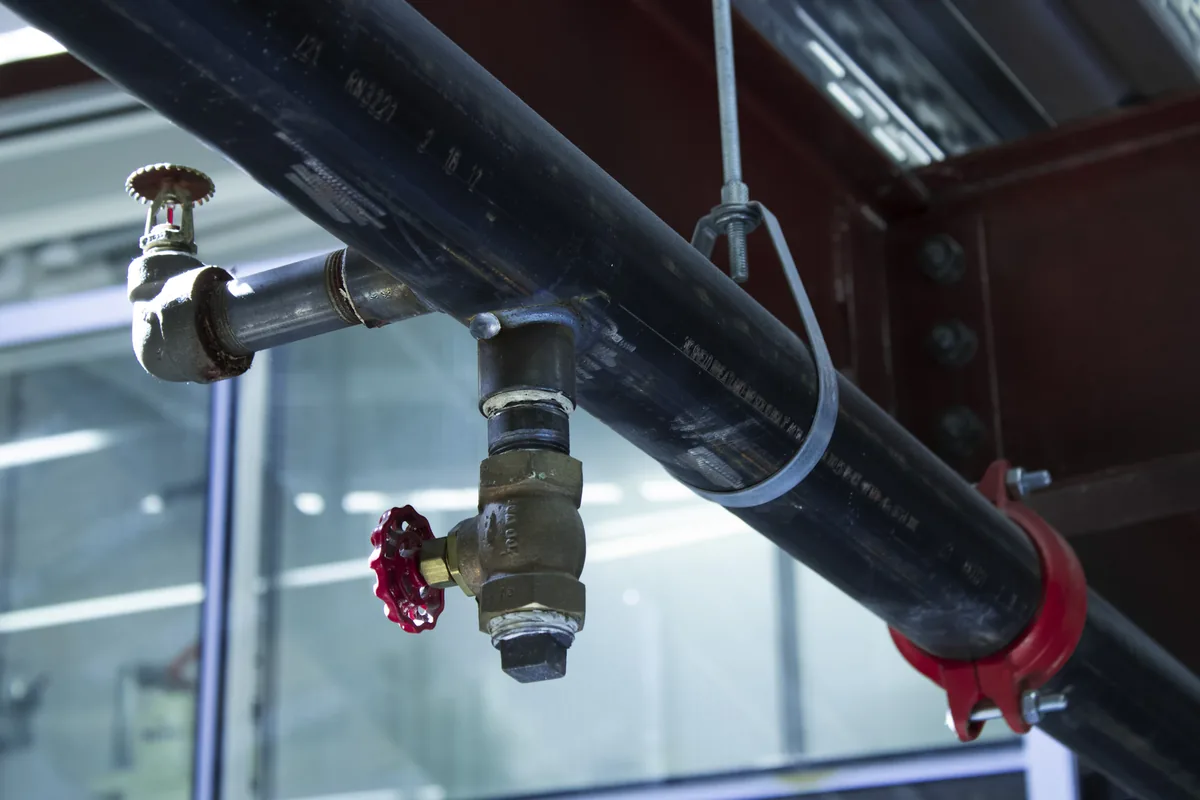 Master plumber installing repiping services equipment in a Florida home